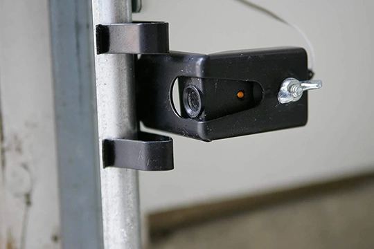 Quality installation of safety sensors, ensuring optimal garage door function and security.